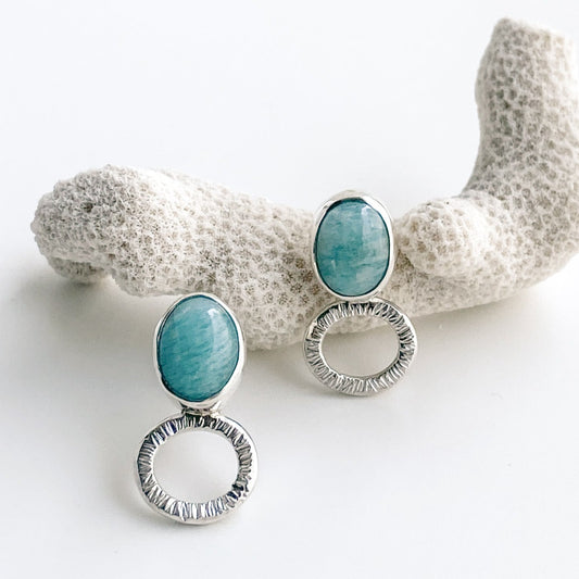 Teal blue-green amazonite stud earrings with silver textured ovals.