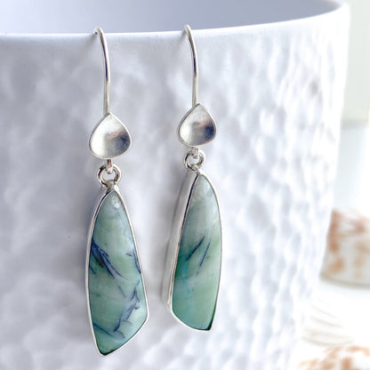 Asymmetric cut opalized wood gemstone earrings in shades of sea green and pale teal with black dendrite inclusions