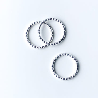 Three silver stacking rings with beaded texture