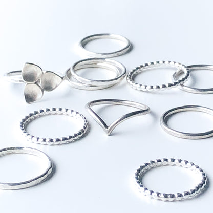A grouping of silver stacking rings