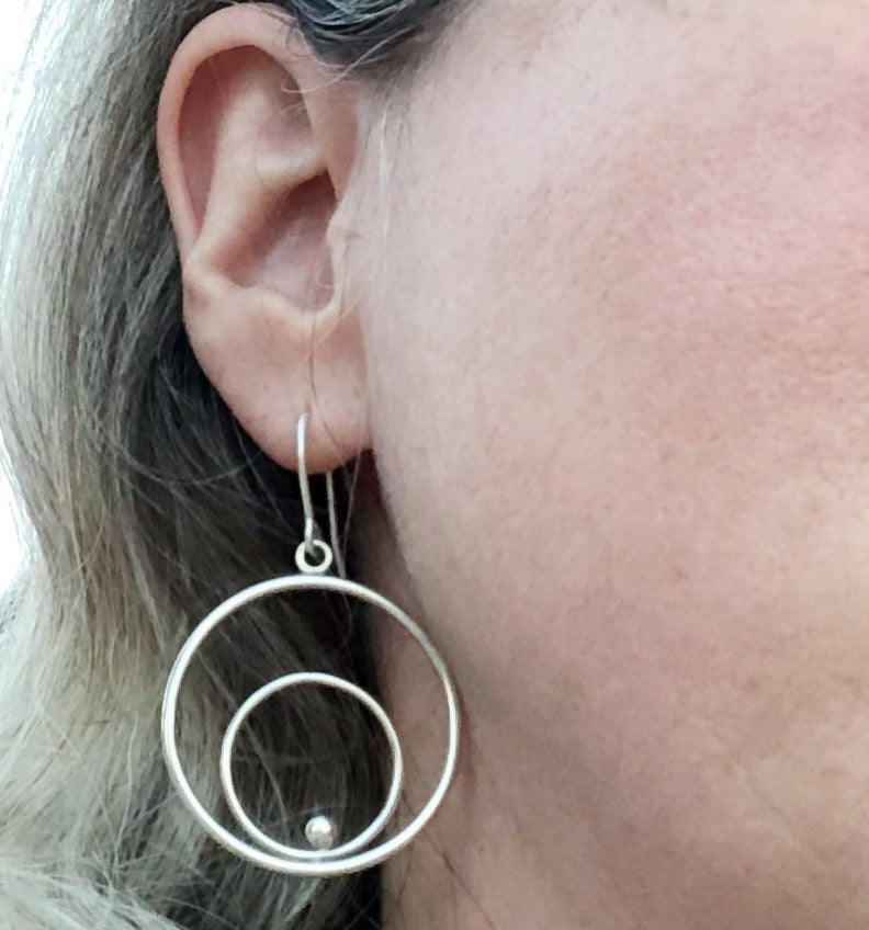 Silver circles hoop earrings on model