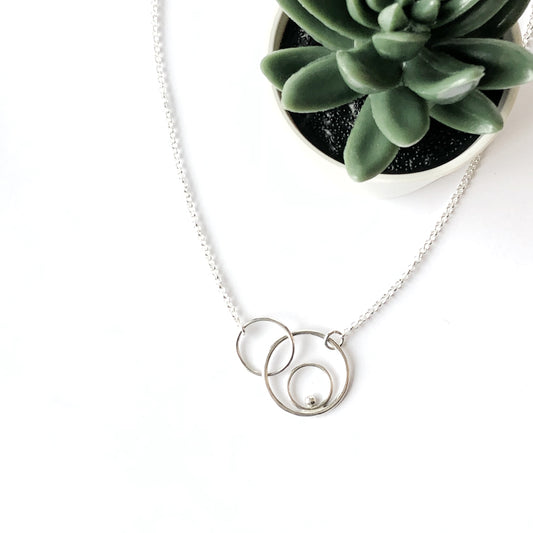 Silver orbital linked circles necklace