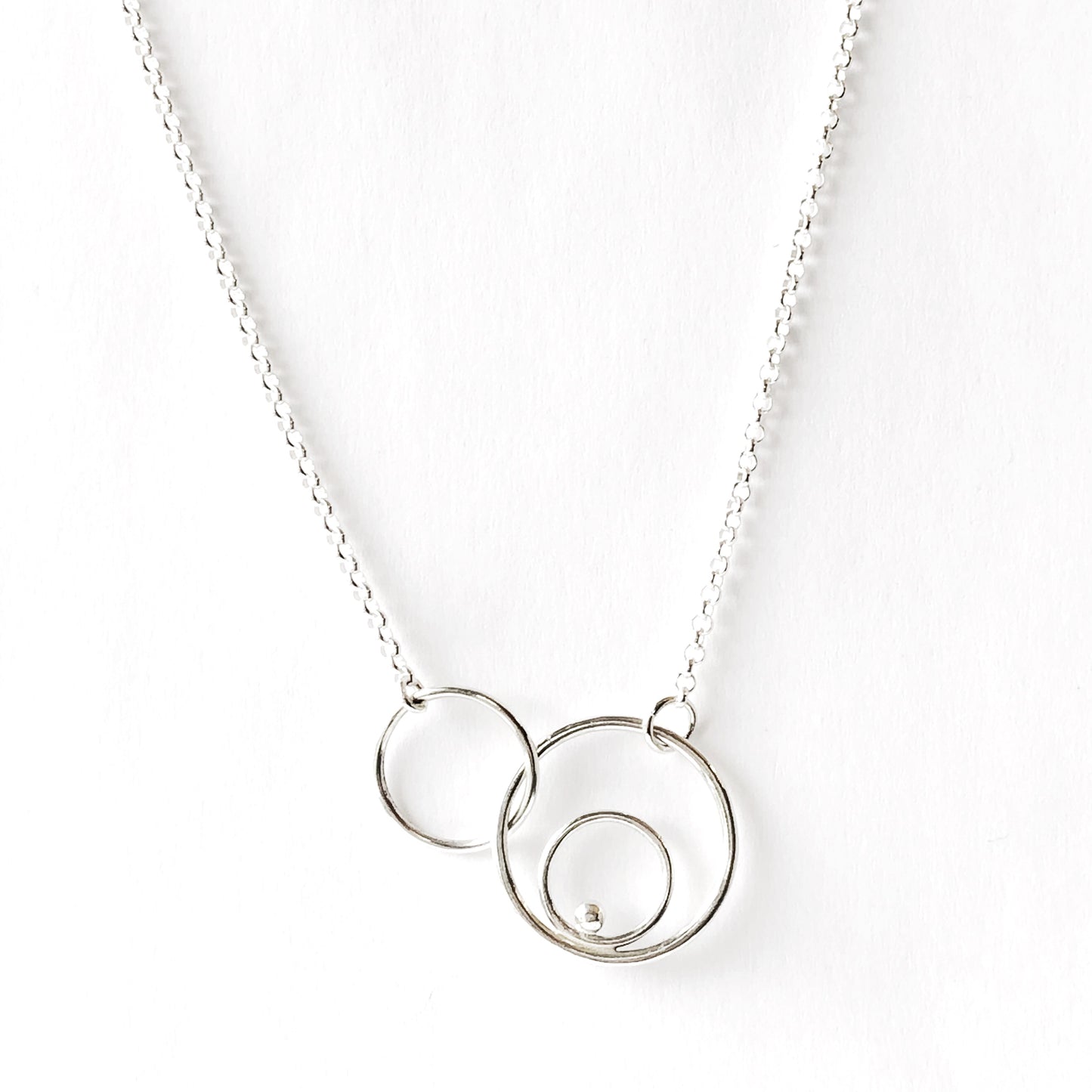 Silver orbital link necklace close up