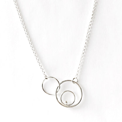 Silver orbital link necklace close up