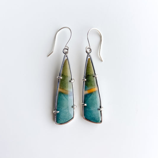 A pair of polychrome jasper stone earrings in shades of teal and olive green and set in sterling silver on a white background